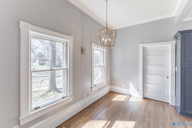 unfurnished dining area with crown molding, light wood-style floors, visible vents, and a wealth of natural light