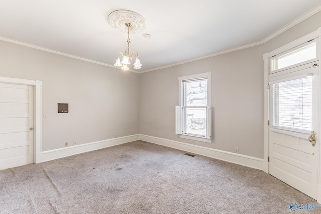 carpeted empty room with visible vents, a healthy amount of sunlight, and ornamental molding