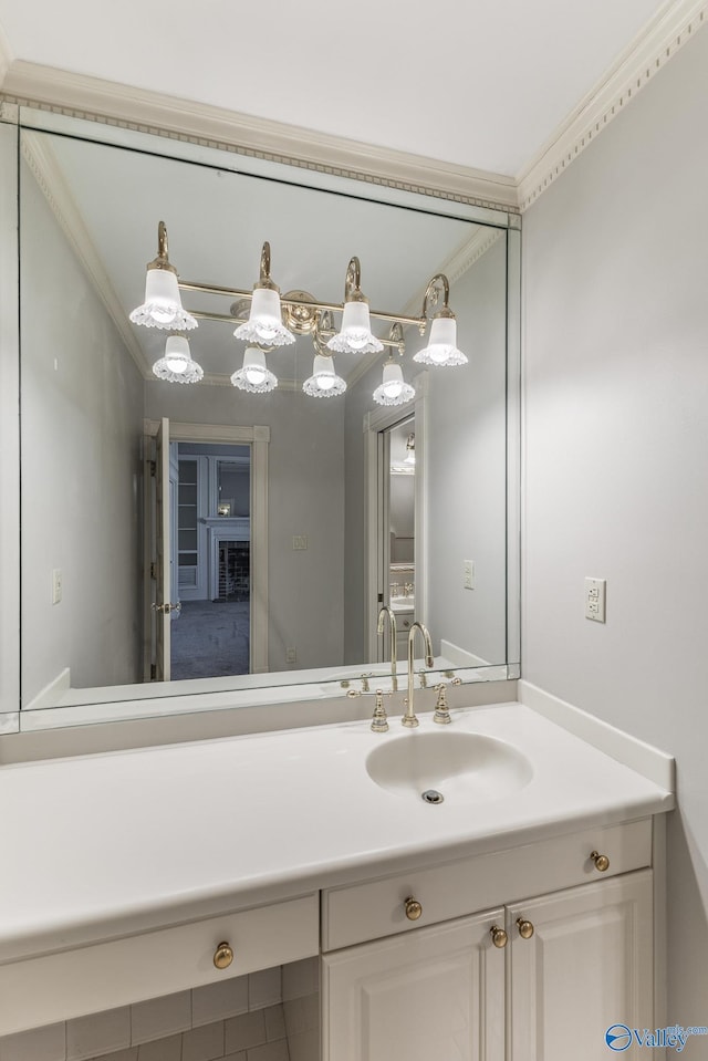 bathroom with ornamental molding and vanity