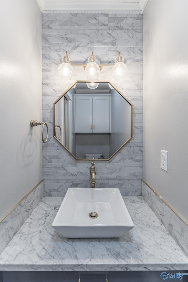 bathroom featuring marble finish floor and a sink