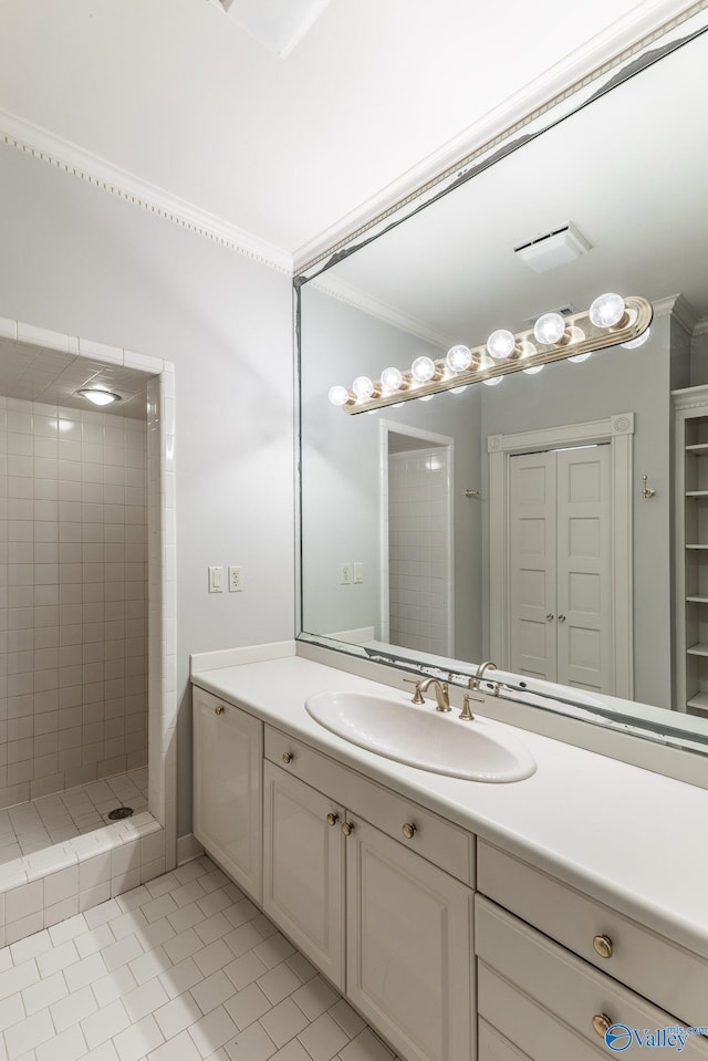 bathroom featuring a shower stall, tile patterned floors, ornamental molding, a closet, and vanity