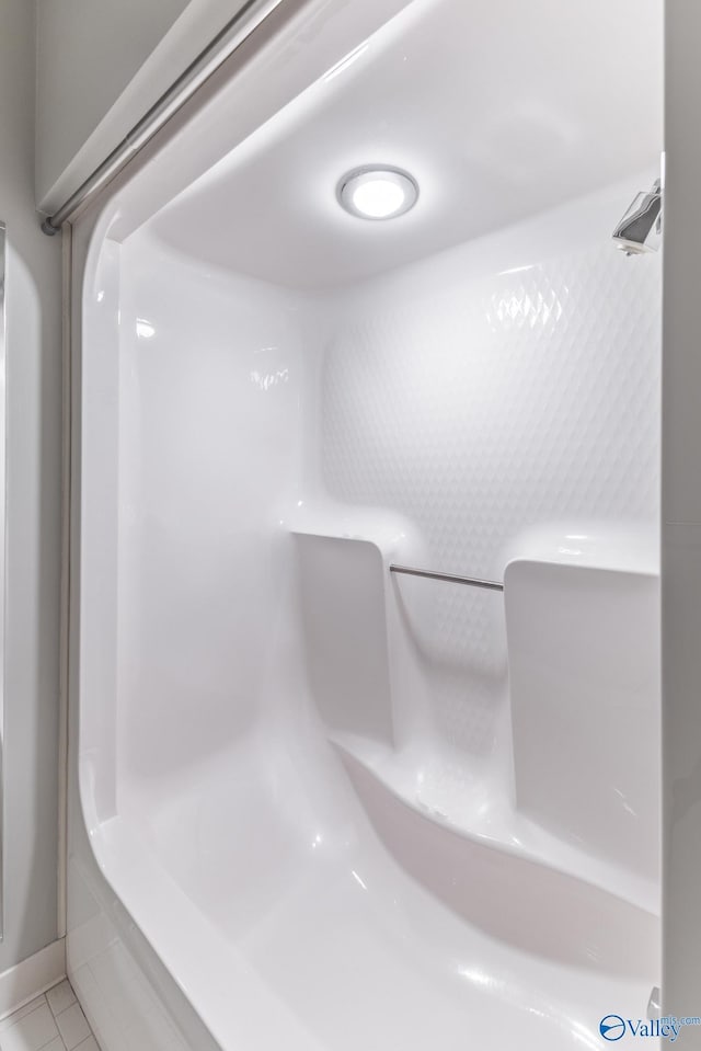 full bath featuring tile patterned floors and a shower