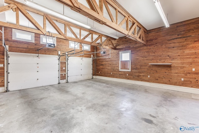 garage featuring wood walls and a garage door opener