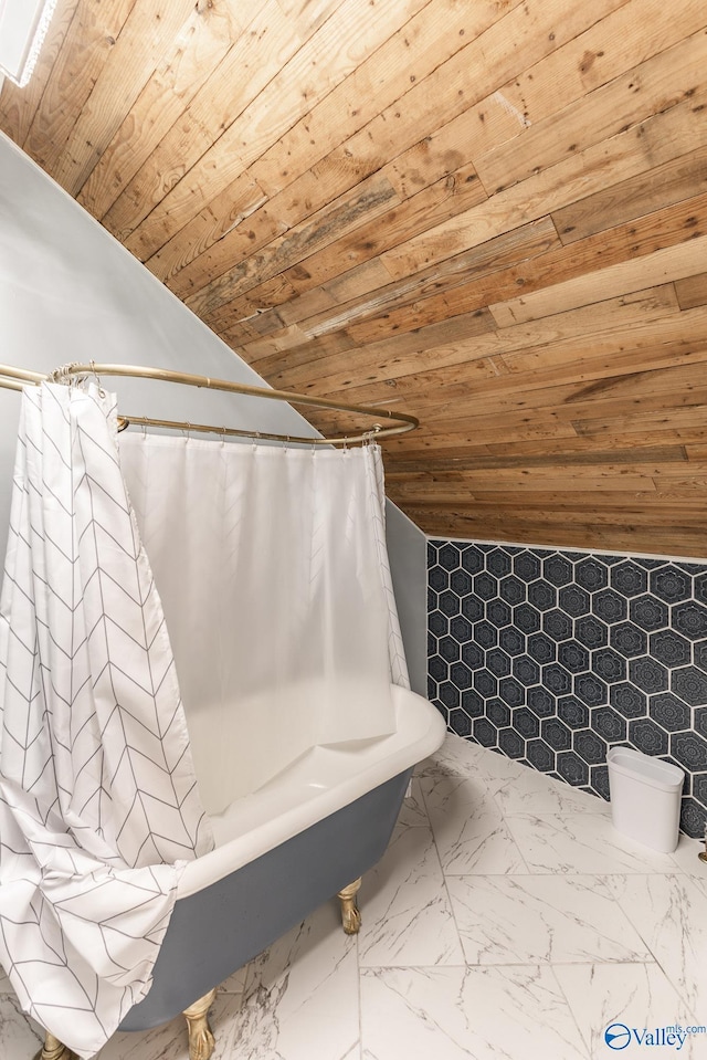 bathroom with lofted ceiling, marble finish floor, and wooden ceiling