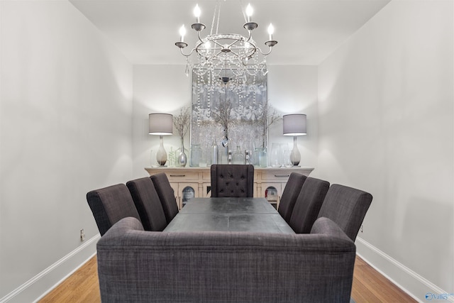 702 5th Ave SE, Cullman, AL 35055 - dining area featuring a notable chandelier, baseboards, and wood finished floors