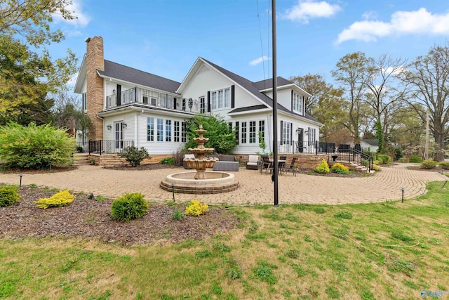 702 5th Ave SE, Cullman, AL 35055 - rear view of property with a patio area, a chimney, and a balcony