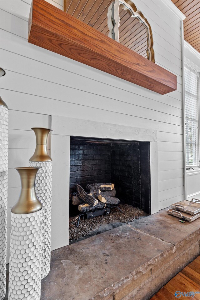 702 5th Ave SE, Cullman, AL 35055 - room details with wood walls, wood finished floors, and a fireplace