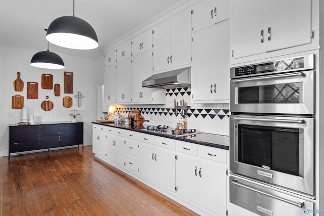 702 5th Ave SE, Cullman, AL 35055 - kitchen with a warming drawer, under cabinet range hood, appliances with stainless steel finishes, dark countertops, and backsplash