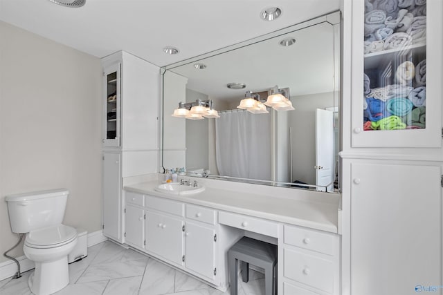 702 5th Ave SE, Cullman, AL 35055 - bathroom featuring toilet, marble finish floor, baseboards, and vanity