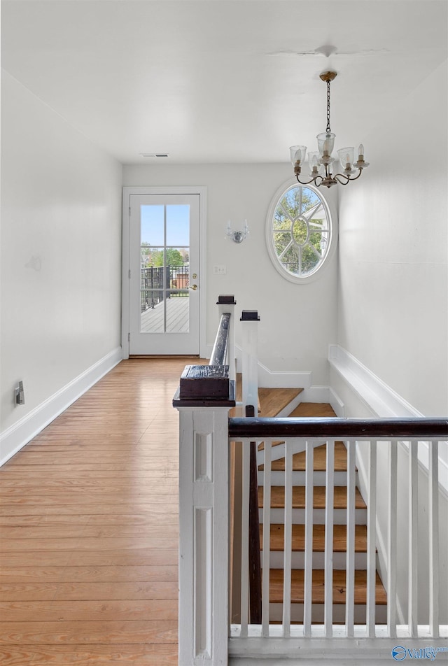 702 5th Ave SE, Cullman, AL 35055 - staircase featuring a healthy amount of sunlight, an inviting chandelier, baseboards, and wood finished floors