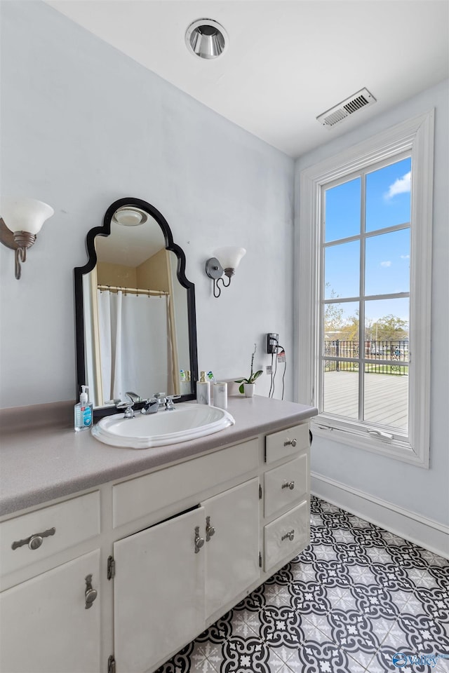 702 5th Ave SE, Cullman, AL 35055 - bathroom with vanity, baseboards, and visible vents