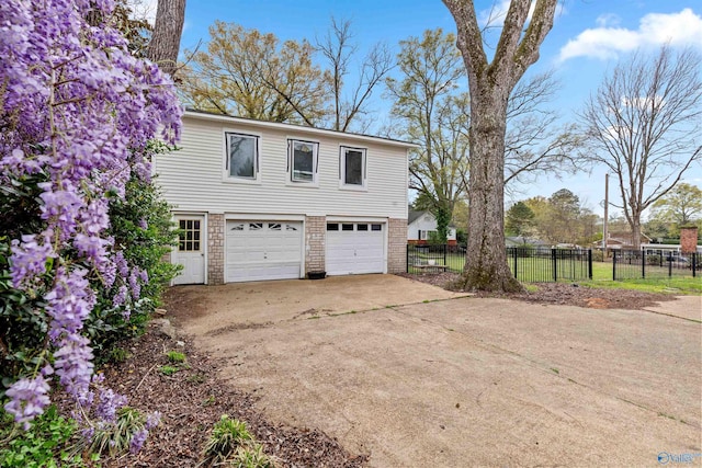 702 5th Ave SE, Cullman, AL 35055 - exterior space with driveway, a garage, fence, and brick siding