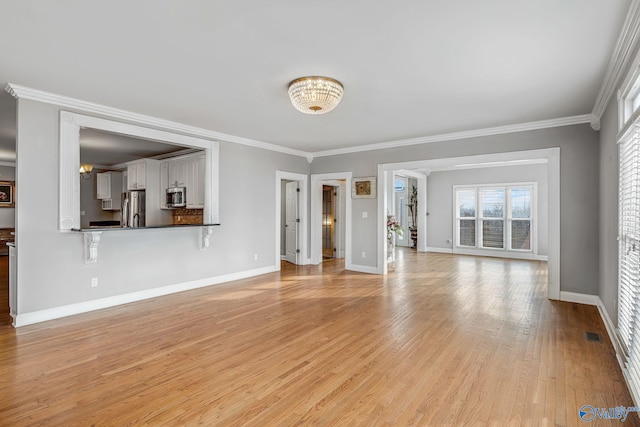 unfurnished living room featuring crown molding and light wood-type flooring