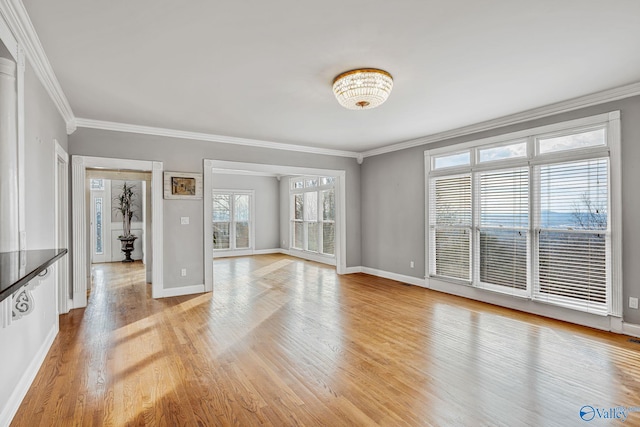 unfurnished living room featuring crown molding and light wood-type flooring