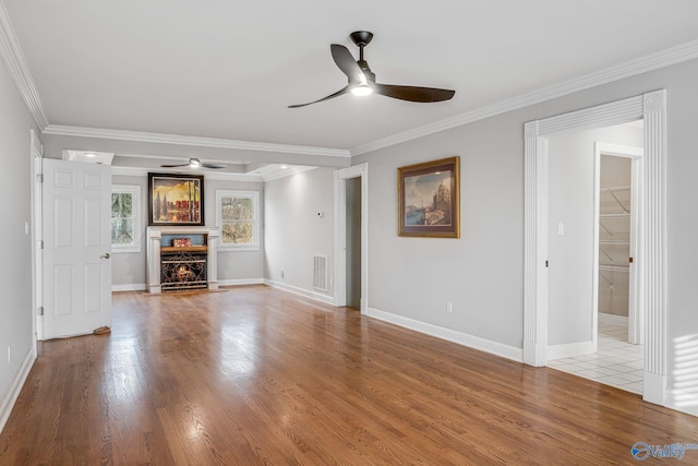 unfurnished living room featuring crown molding, hardwood / wood-style flooring, and ceiling fan