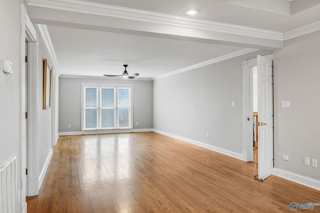 empty room with crown molding, ceiling fan, and light wood-type flooring