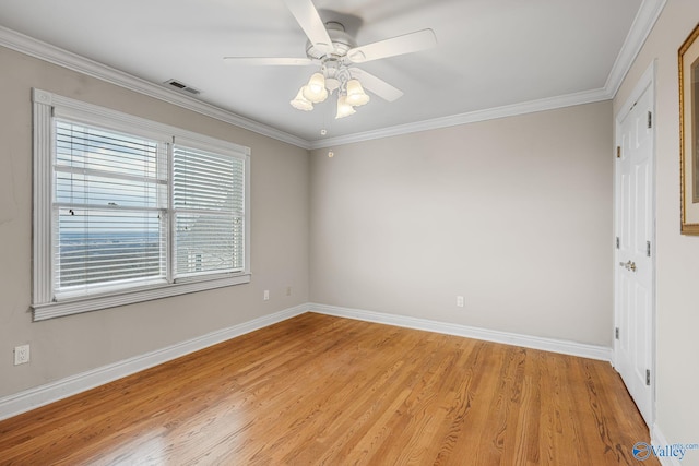 empty room featuring ceiling fan, ornamental molding, and light hardwood / wood-style floors