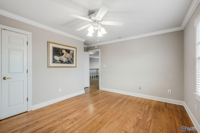 empty room featuring crown molding, ceiling fan, and light hardwood / wood-style floors