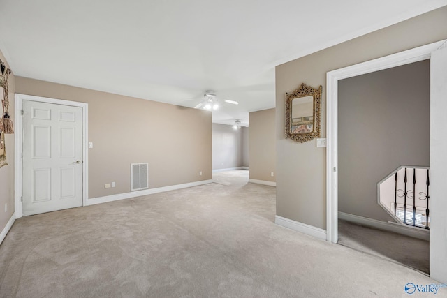 spare room with light colored carpet and ceiling fan