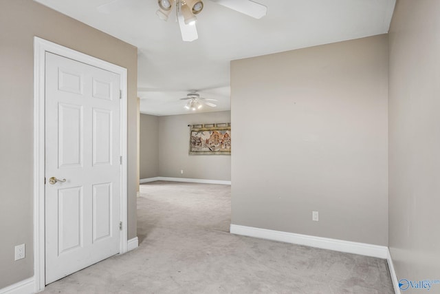 carpeted spare room featuring ceiling fan