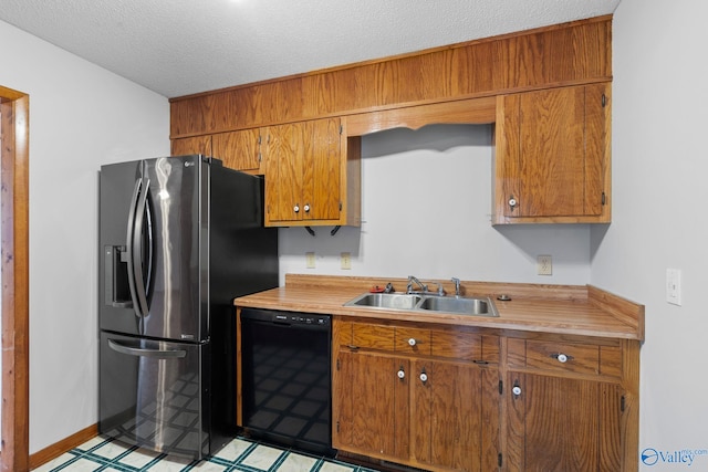 kitchen featuring sink, a textured ceiling, black dishwasher, and stainless steel refrigerator with ice dispenser