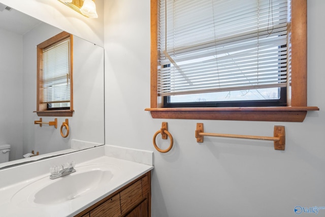 bathroom with vanity and toilet