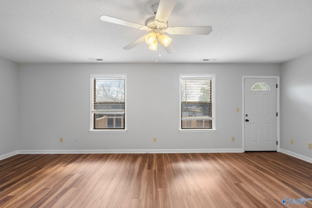 entryway featuring hardwood / wood-style flooring, ceiling fan, a textured ceiling, and a wealth of natural light