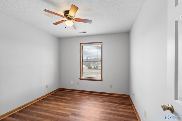 spare room with ceiling fan, dark hardwood / wood-style flooring, and a textured ceiling