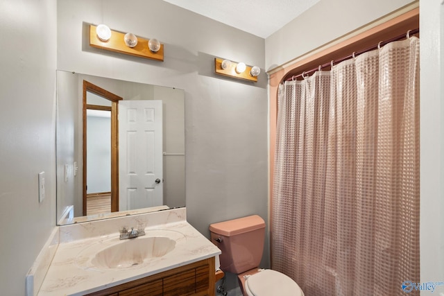 bathroom with a shower with curtain, vanity, and toilet