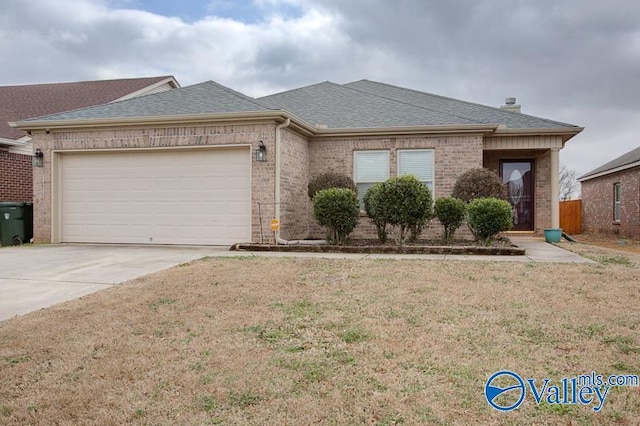 ranch-style home with a garage and a front yard