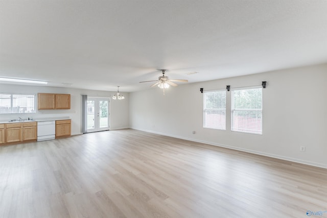 unfurnished living room featuring ceiling fan with notable chandelier, light wood-type flooring, and sink