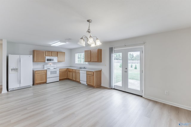 kitchen featuring hanging light fixtures, white appliances, french doors, an inviting chandelier, and light wood-type flooring