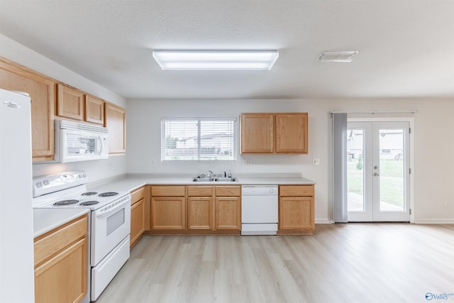 kitchen with white appliances, light hardwood / wood-style flooring, french doors, and plenty of natural light