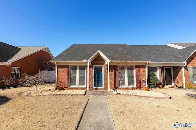 single story home with brick siding and a shingled roof