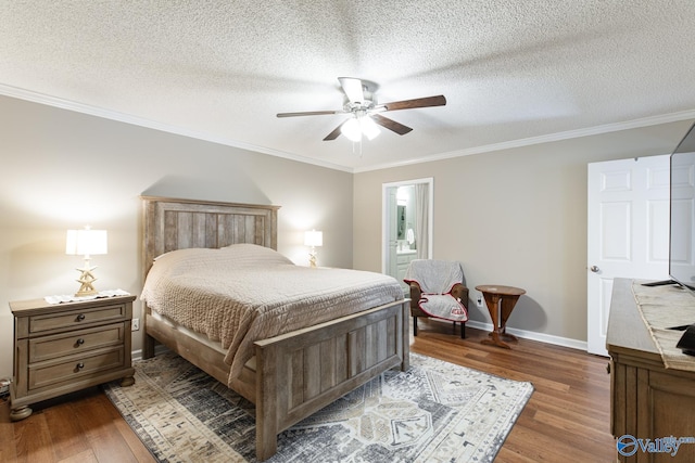 bedroom featuring ceiling fan, a textured ceiling, wood finished floors, baseboards, and crown molding