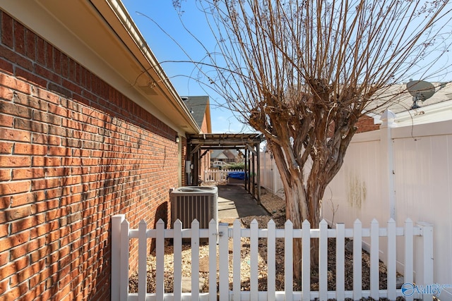 view of yard with fence private yard, a gate, and central AC unit