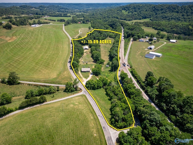 birds eye view of property with a rural view