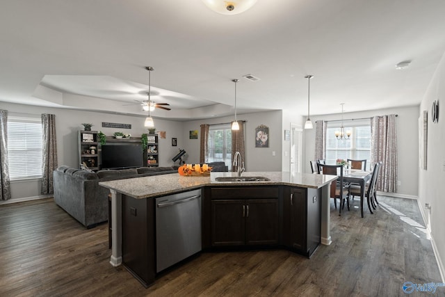 kitchen featuring ceiling fan with notable chandelier, sink, a kitchen island with sink, and stainless steel dishwasher