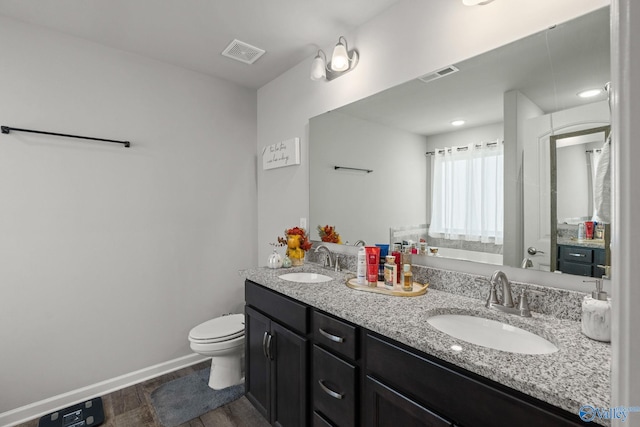 bathroom with vanity, hardwood / wood-style floors, and toilet