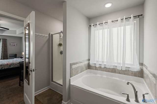 bathroom with plenty of natural light and separate shower and tub