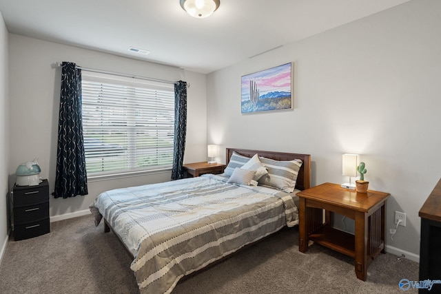 bedroom with dark colored carpet