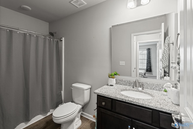 bathroom with vanity, hardwood / wood-style floors, and toilet