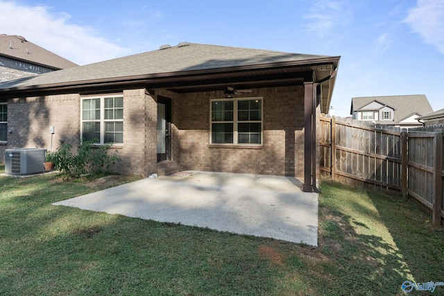 rear view of house with a patio, central AC, ceiling fan, and a yard