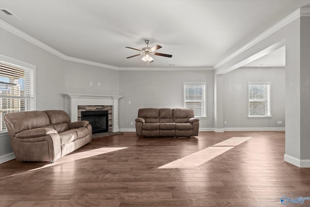 unfurnished living room featuring crown molding, dark hardwood / wood-style floors, ceiling fan, and a fireplace