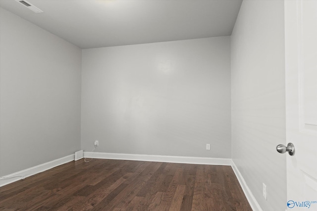 spare room featuring dark hardwood / wood-style flooring