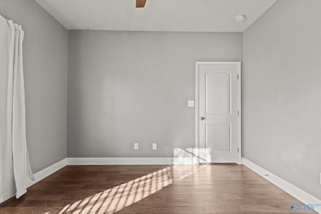 spare room with ceiling fan and dark hardwood / wood-style flooring