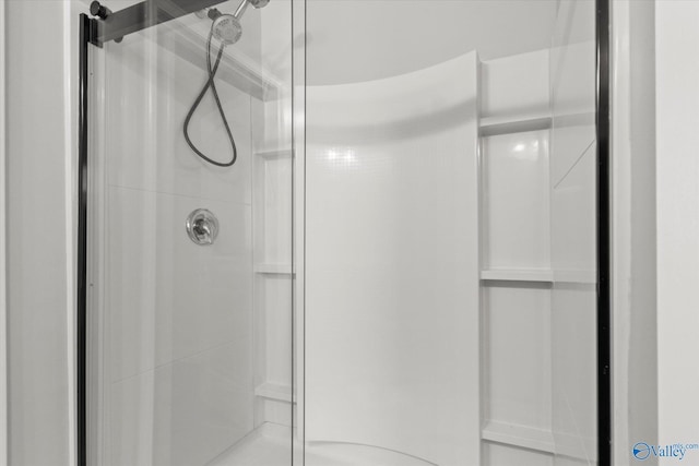 bathroom with a shower with door