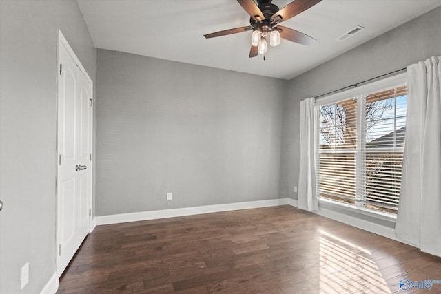 unfurnished room with ceiling fan and dark hardwood / wood-style flooring