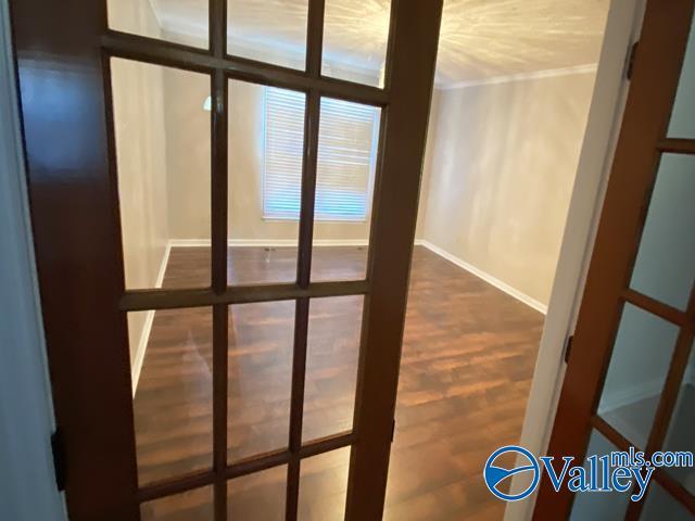 entryway featuring crown molding, hardwood / wood-style flooring, and french doors