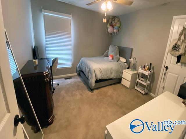 carpeted bedroom featuring ceiling fan